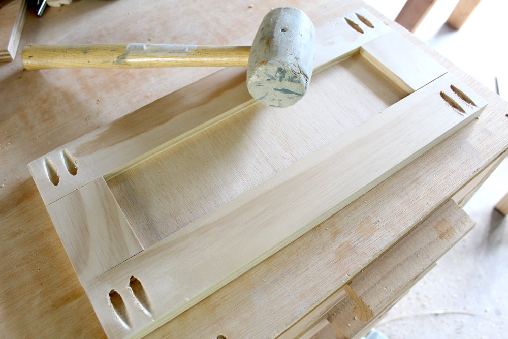 Assembling drawer front pieces with a mallet
